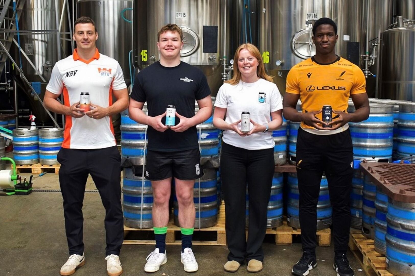 4 people standing in a row, all holding a can of beer.