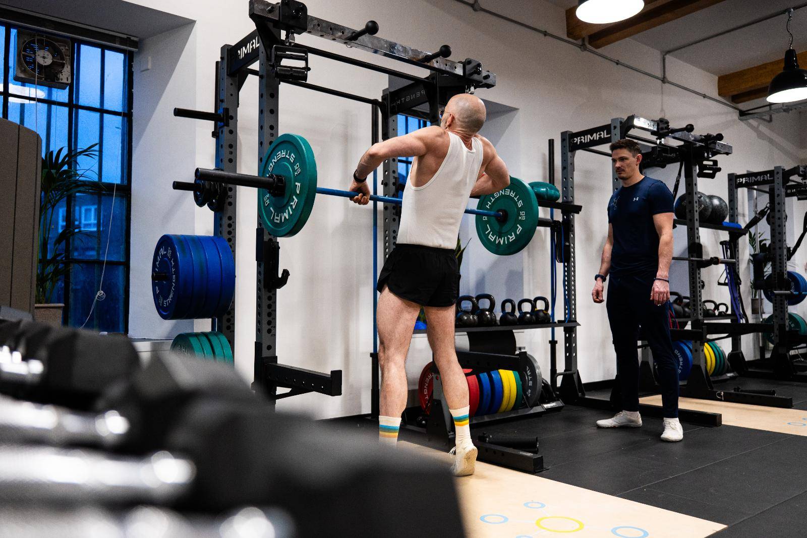 Person in gym being helped by Personal Trainer from Health by Science Personal Training