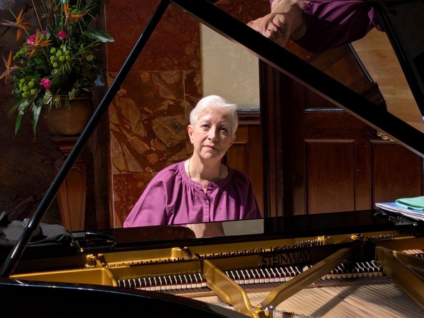 A woman sitting at a piano.