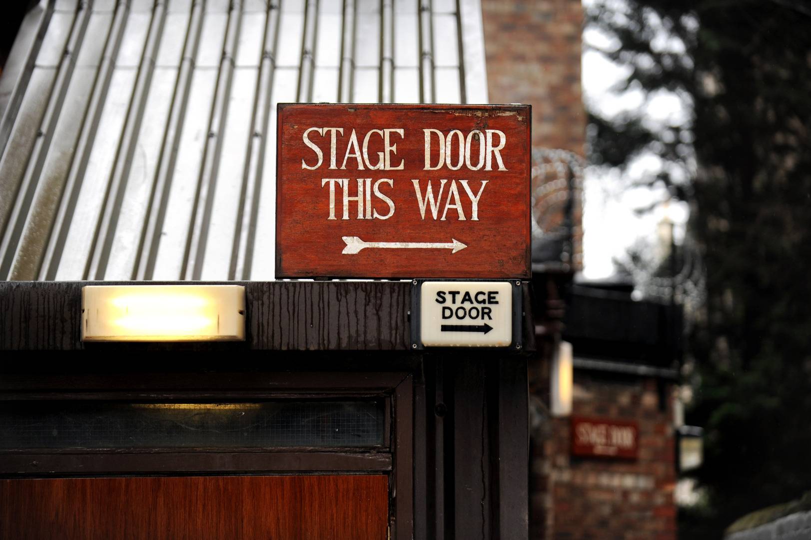 A wooden sign points to stage door this way,© Jane Barlow