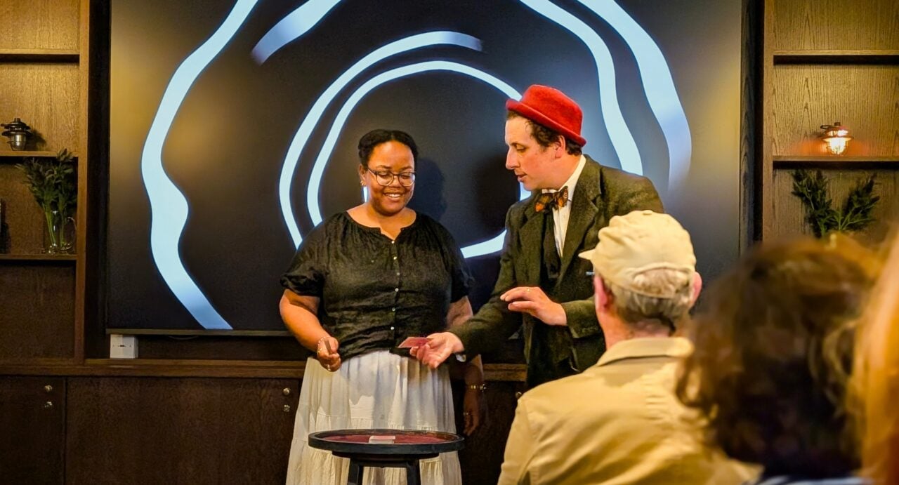 Magician performing a magic trick for a group of people
