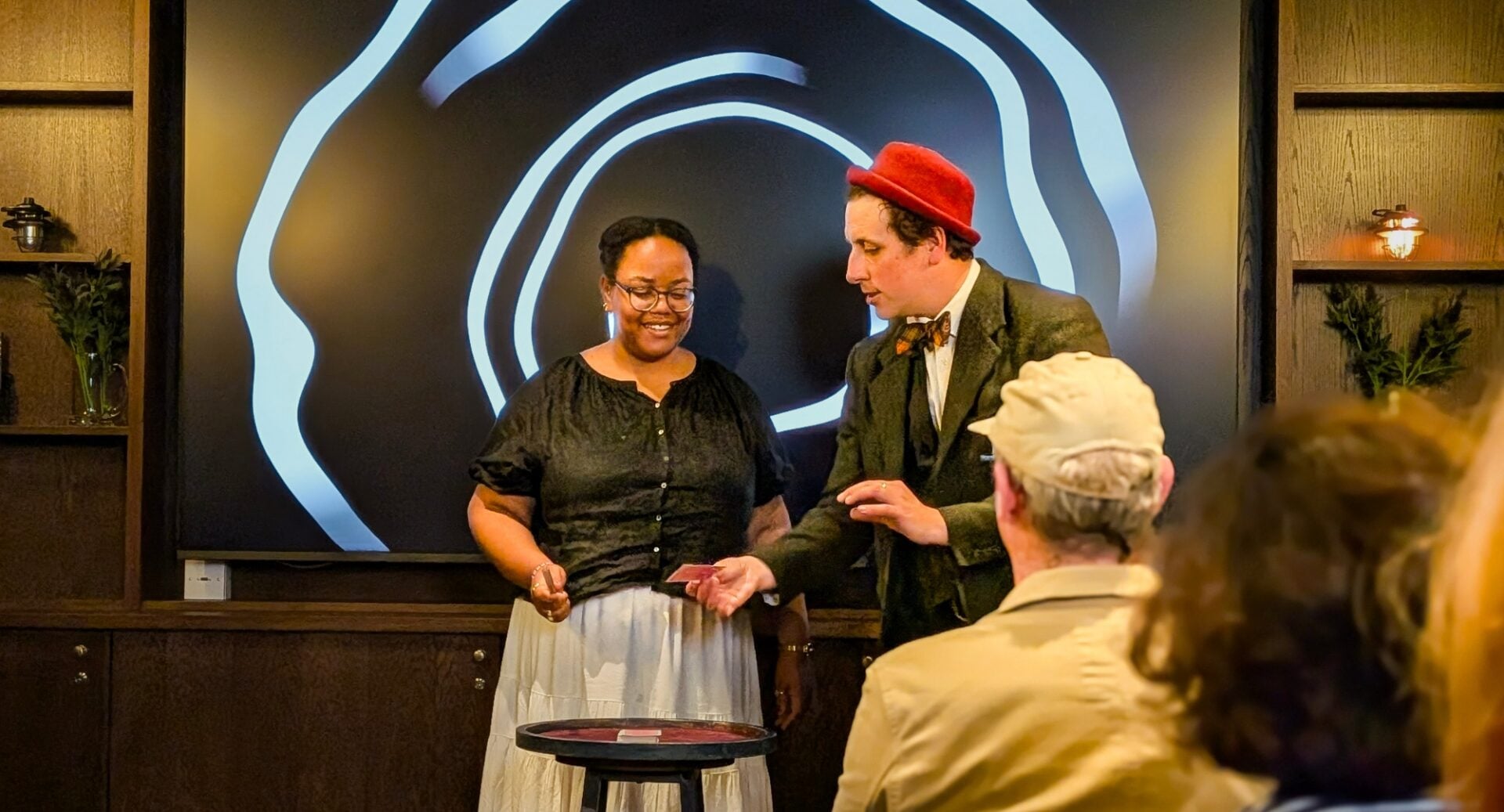 Magician performing a magic trick for a group of people