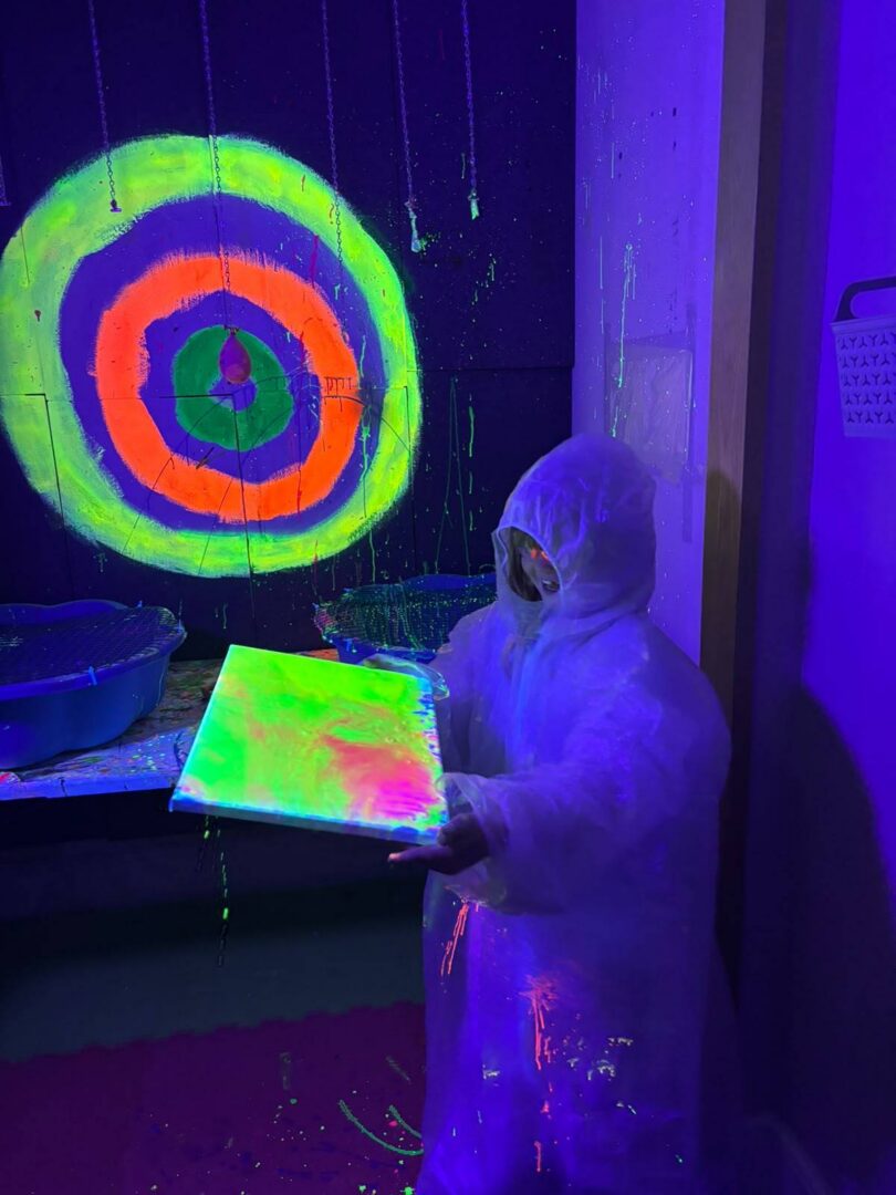 Our darts area where participants throw darts to burst paint-filled balloons onto their canvases.
