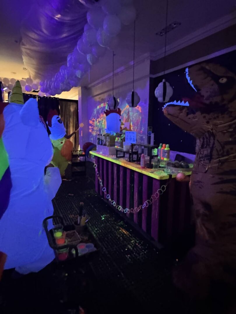 A inflatable session in full swing. There's an inflatable unicorn, 2 chickens and a dinosaur.