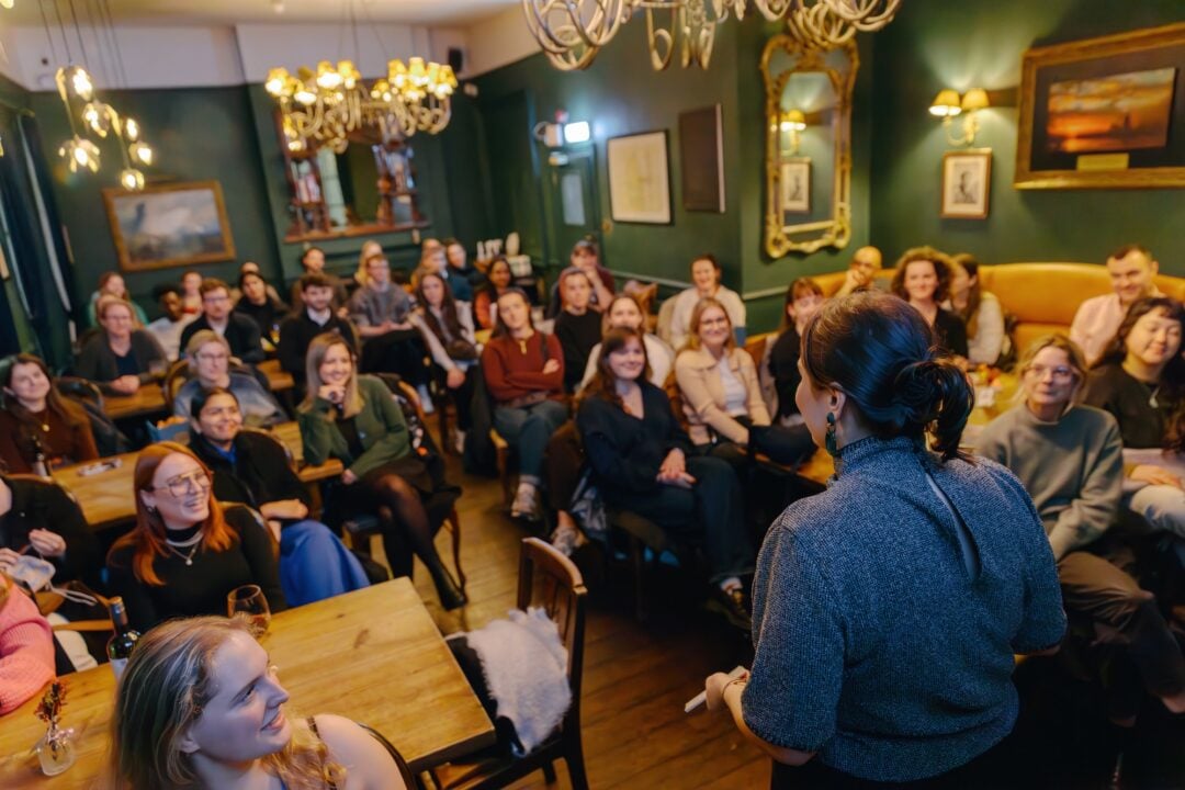 Pints of Knowledge Speaker with audience in background.
