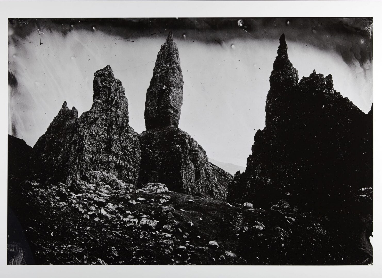 Black and white photo of a pointed ridge of mountains.