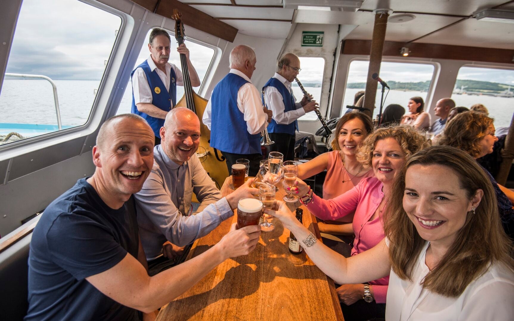 People enjoying themselves listenting to band on Maid of the Forth Jazz Cruise