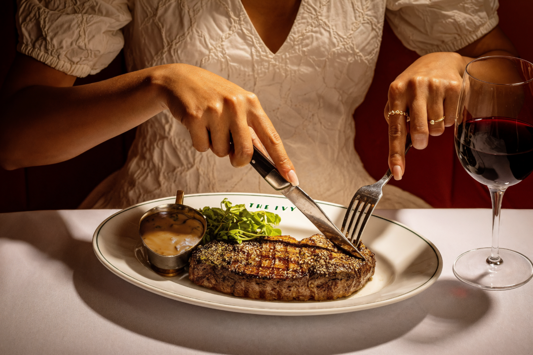 A woman cutting a steak