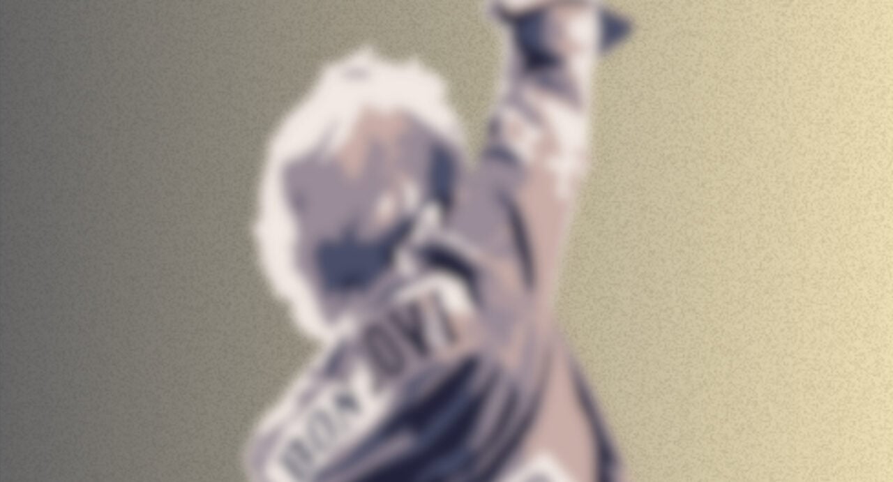 Blurry image of the back of a singer, standing with one arm in the air.