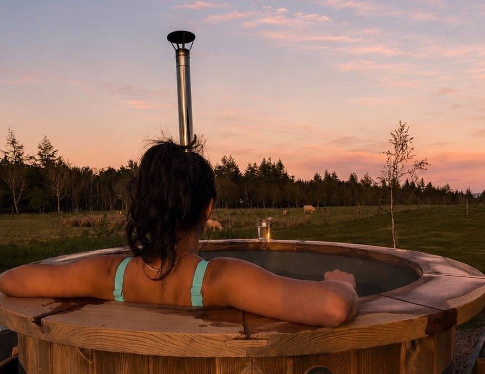Woman sitting in hot tub.,© Pentland Shepherd Huts