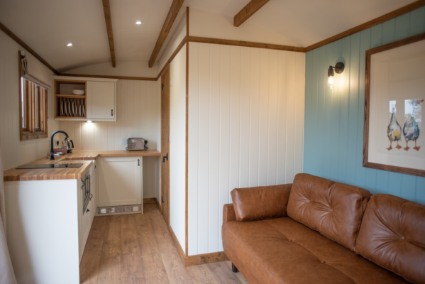 Kitchen & Sofa in Shepherd Hut,© Pentland Shepherd Huts