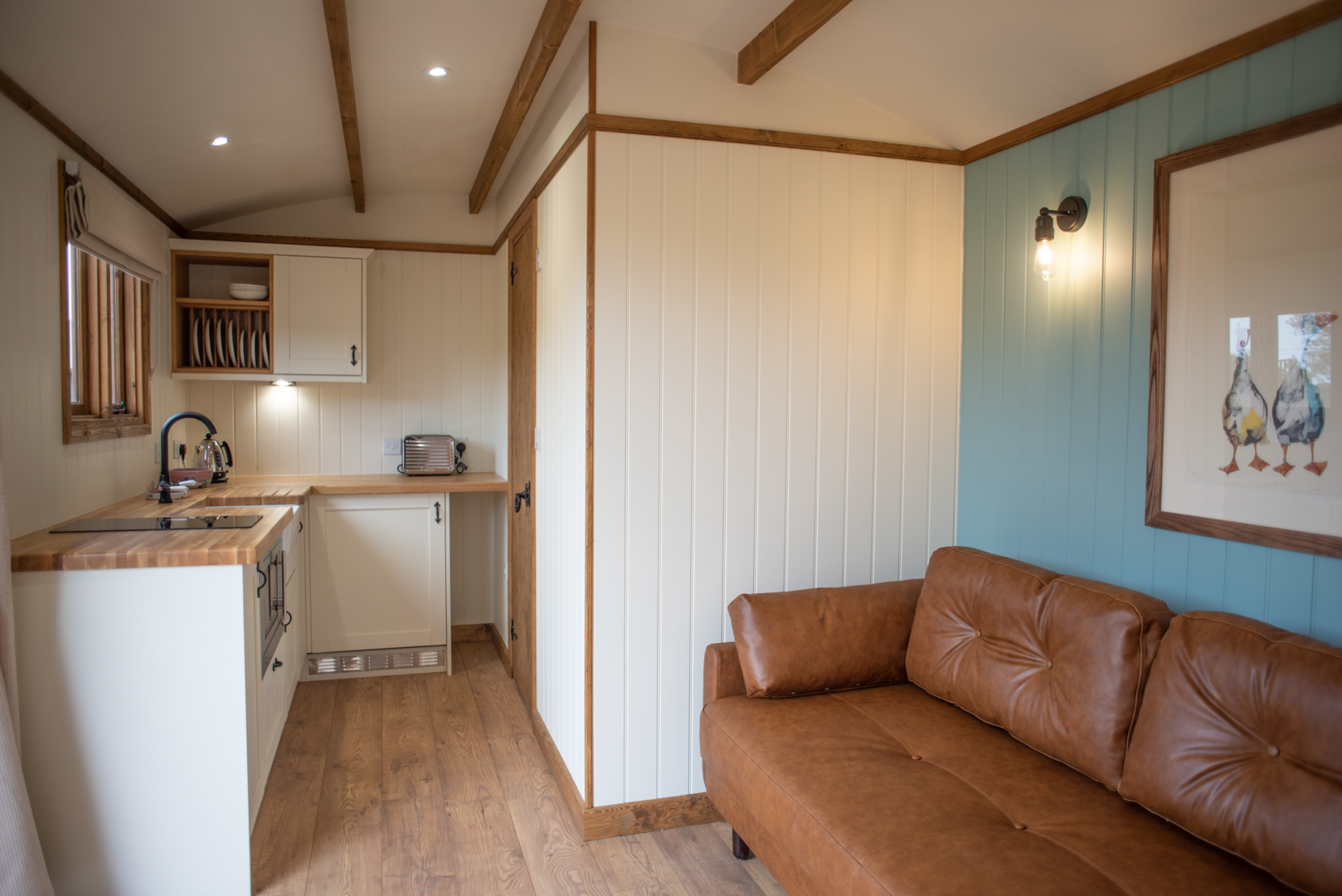 Kitchen & Sofa in Shepherd Hut,© Pentland Shepherd Huts