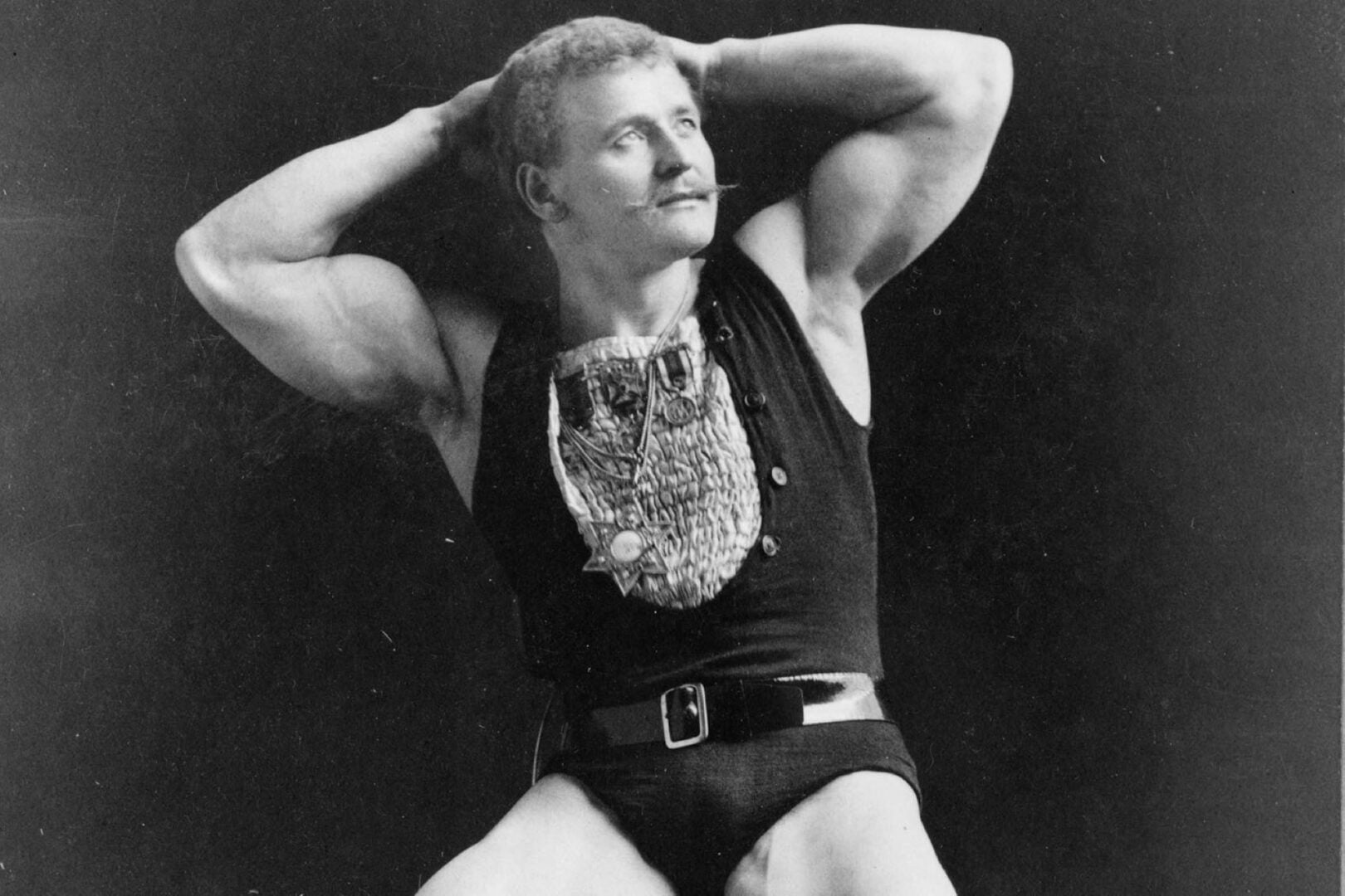 Black and white photo of a man wearing gym clothing.