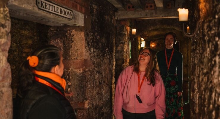 A guide leading a tour group around Mercat Vaults