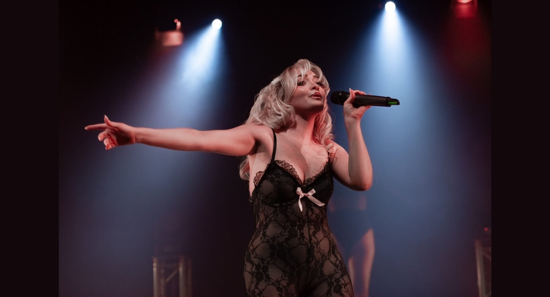 A woman singing on stage.