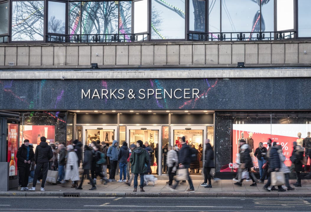 The pavement of Princes Street in Edinburgh busy with people in front of the main entrance to Marks & Spencer, during the run-up to Christmas.