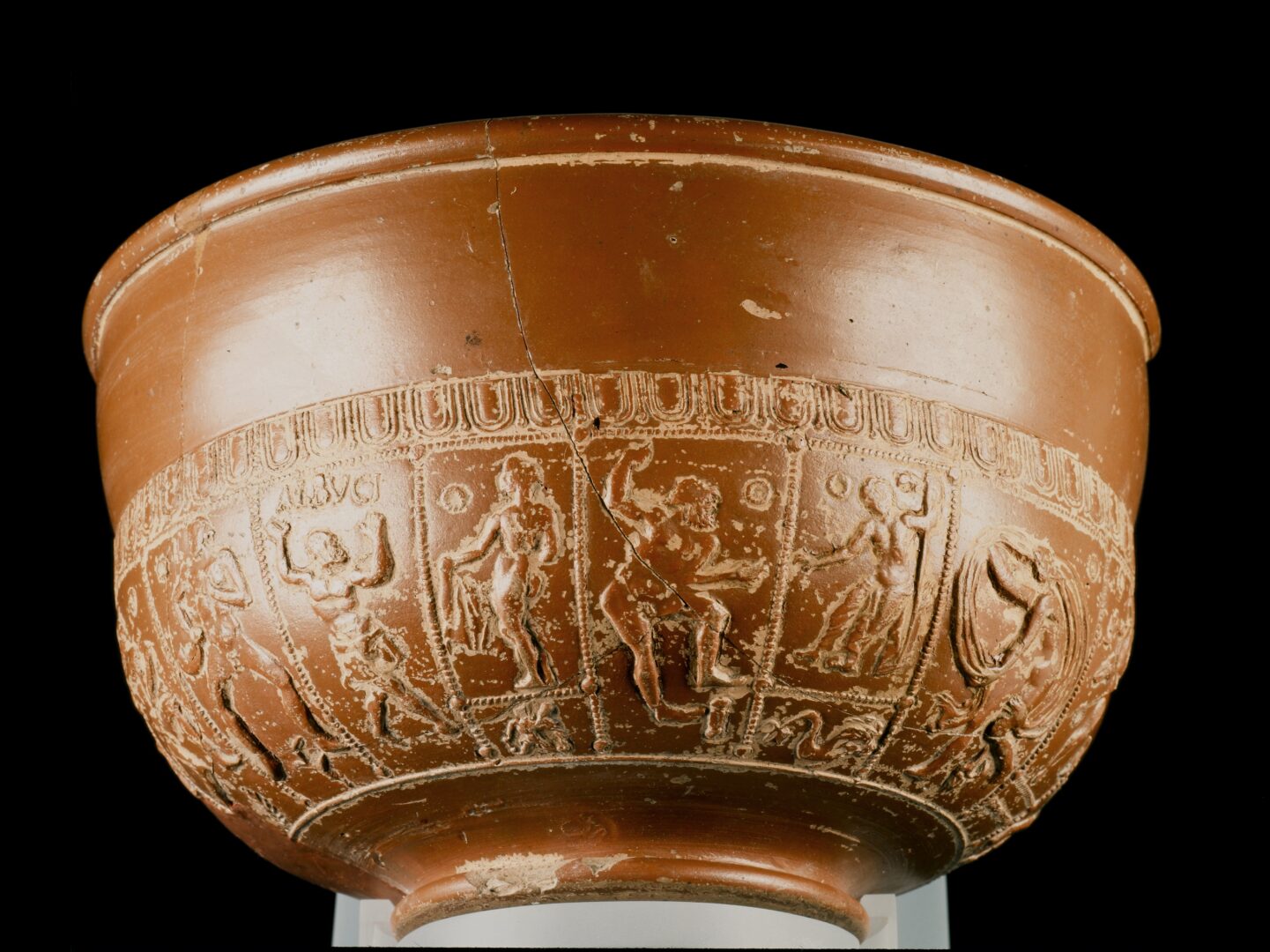 A light brown bowl, with scenes on base.
