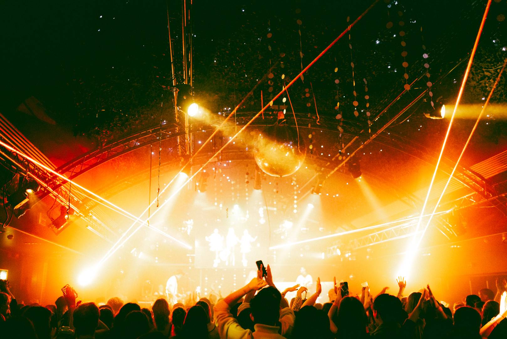 Crowd looking towards a stage with band playing