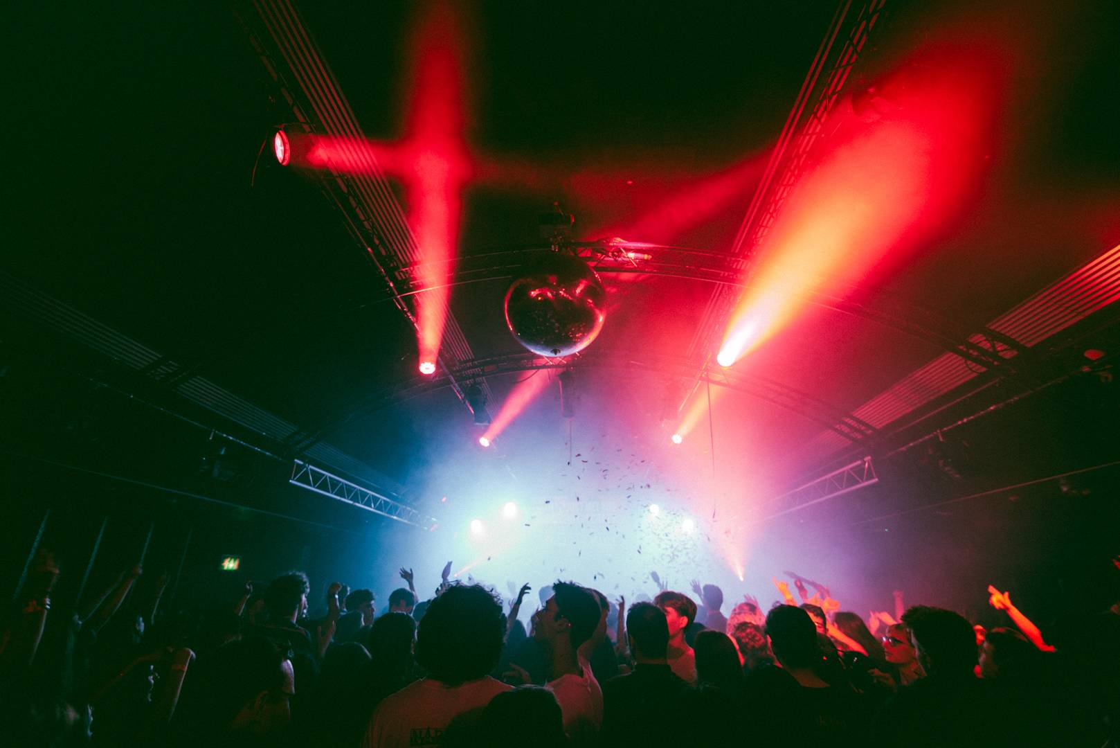 Disco ball and people dancing under it