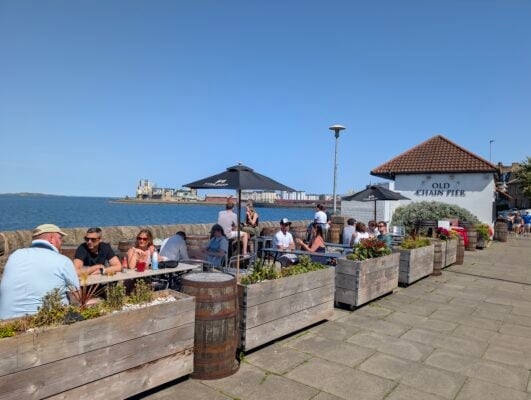 The Outdoor seating at Old Chair Pier with People sitting on sunny day