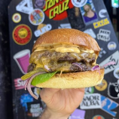 Hand holding a Lioness of Leith beef-burger