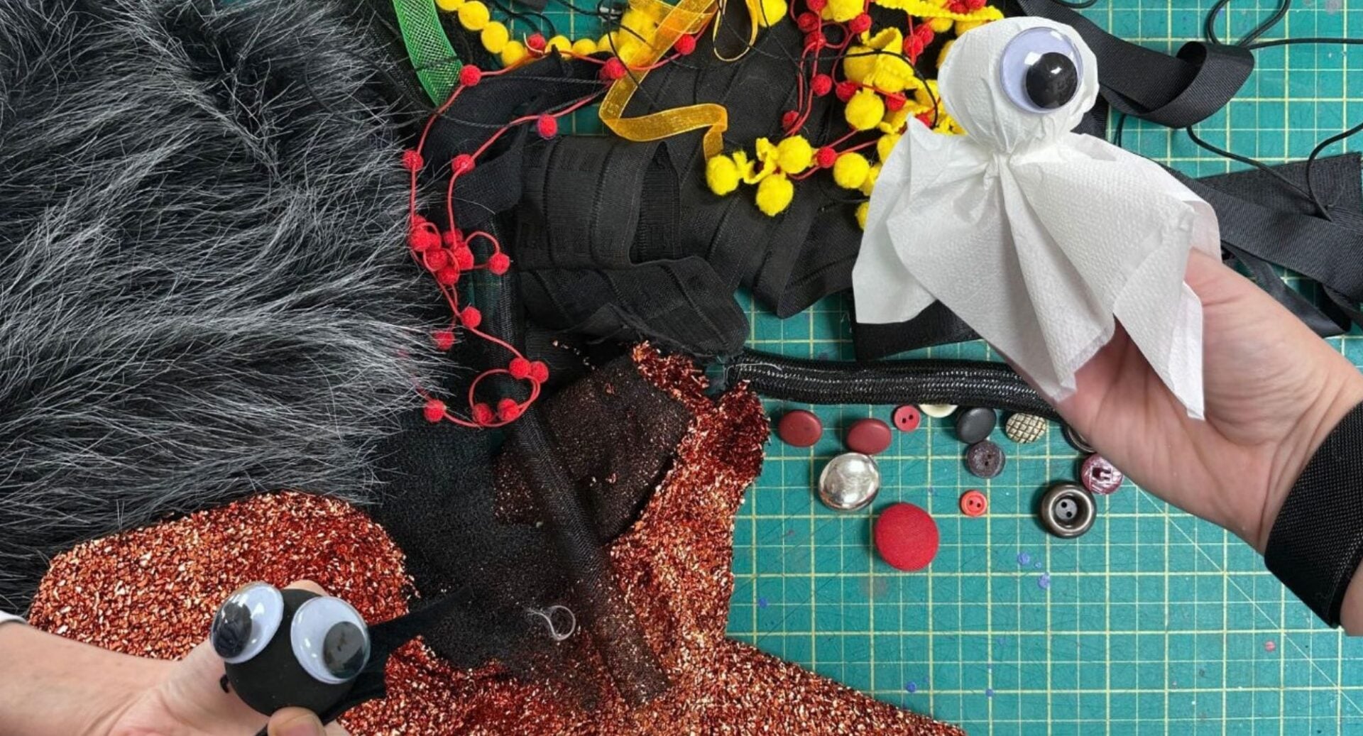 Table top, with various bits of material and buttons.