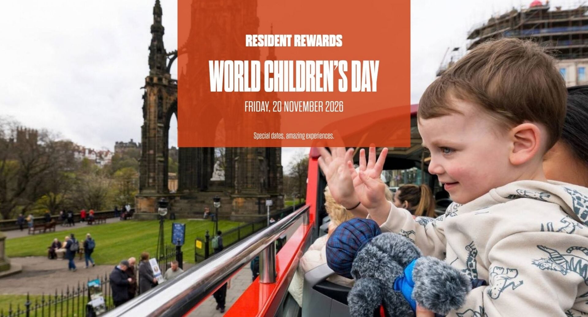 Child waving on top deck of Edinburgh Bus Tours Bus with Scott Monument in background