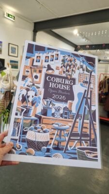 A poster print of Coburg House with Coburg House interior in background.