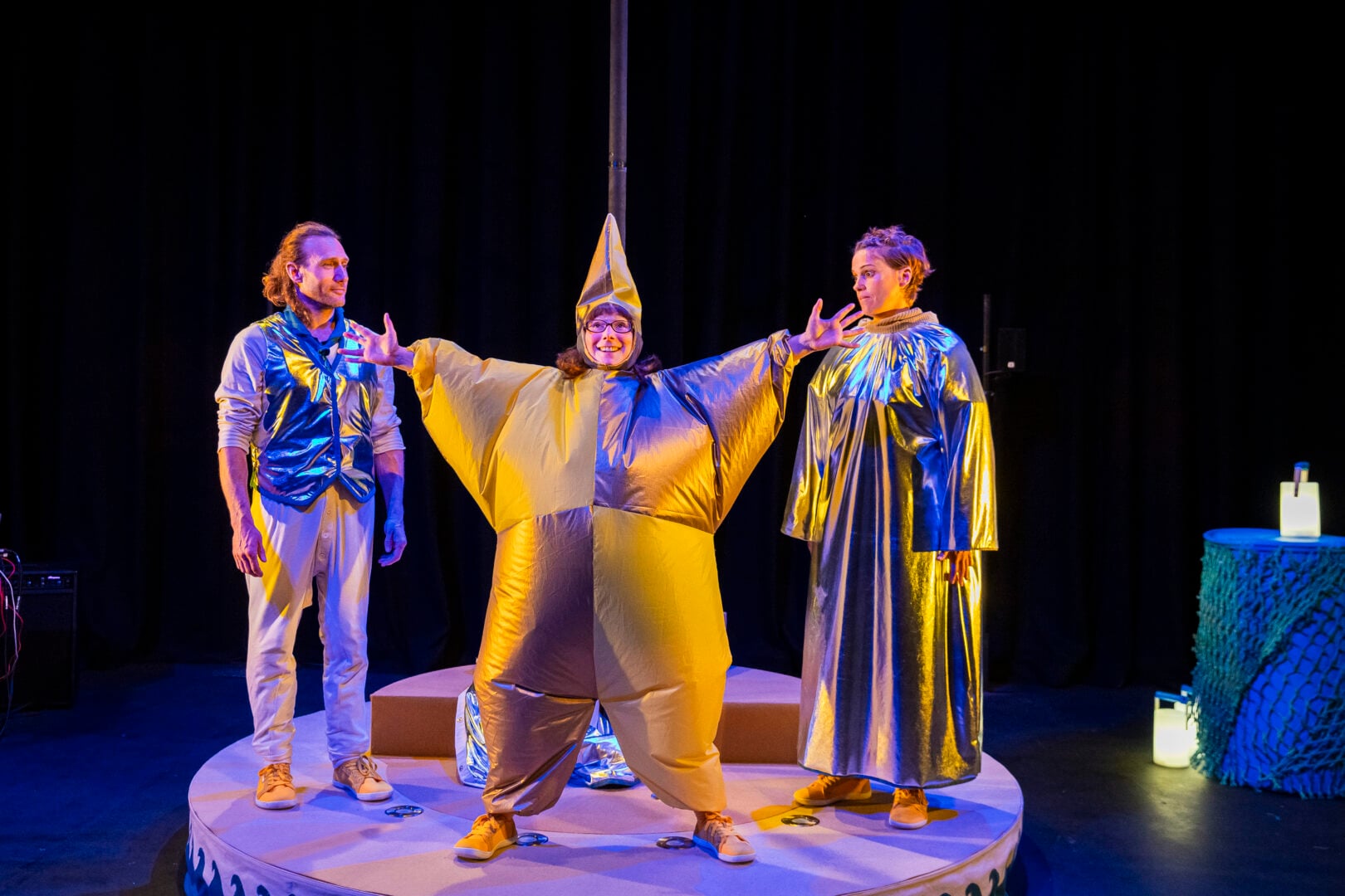 A woman dressed up as a gold star on stage