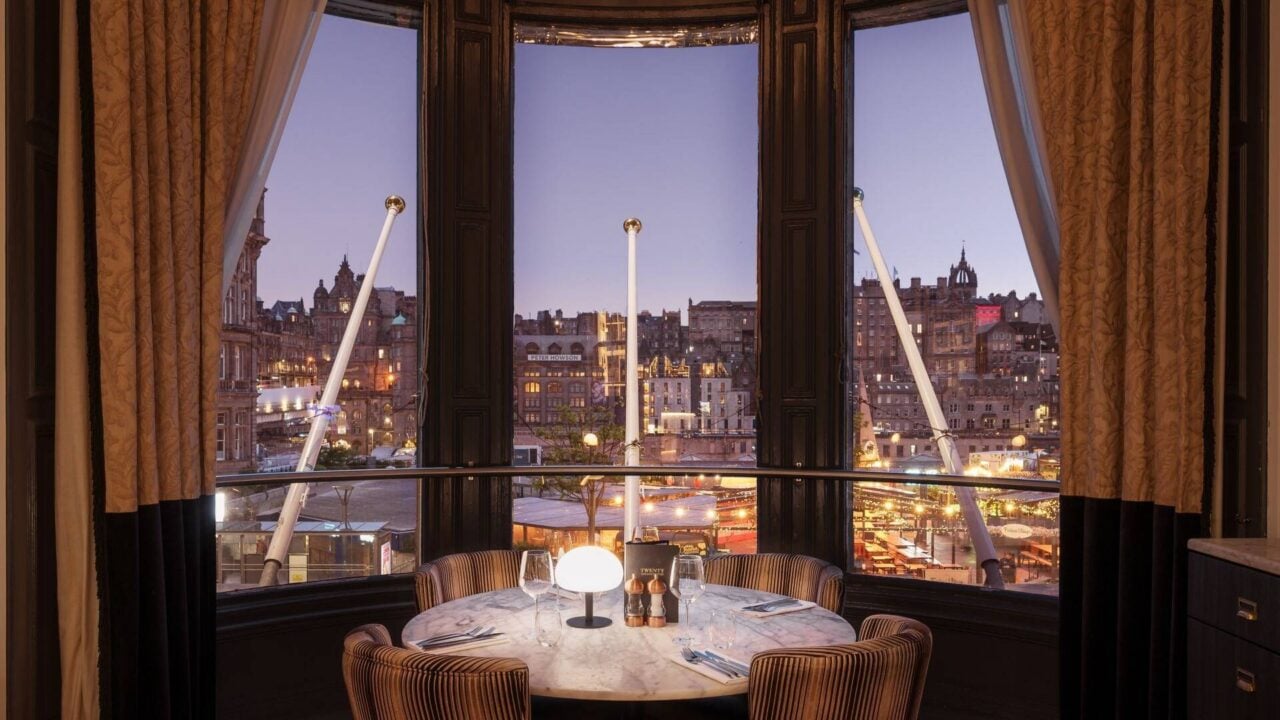 A table for four in a bay window at Twenty, looking out over Edinburgh’s Old Town at dusk.