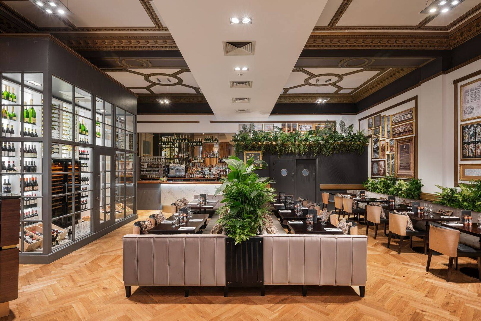 Wide shot of Twenty's dining room with 3 rows of tables and foliage