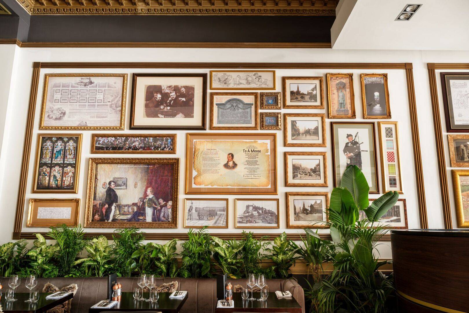 Twenty's wall adorned with framed pictures of literary history